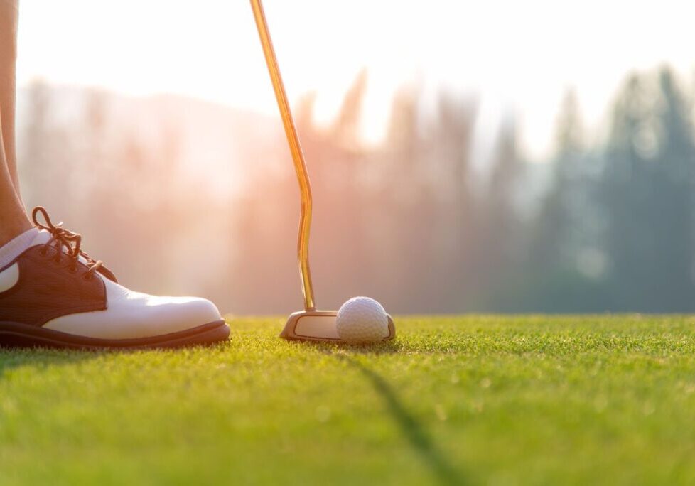 golfer getting ready to swing with putter