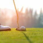 golfer getting ready to swing with putter