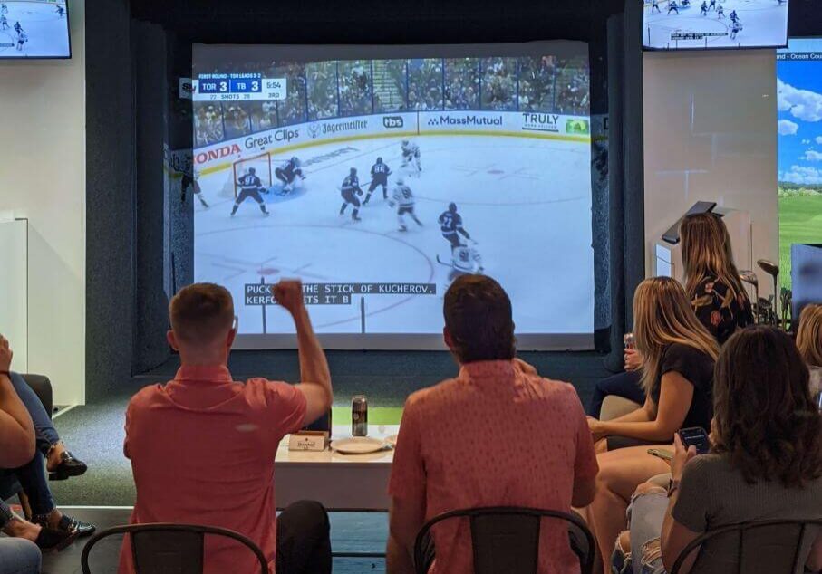 patrons enjoying the game at golf simulator lounge in Toronto